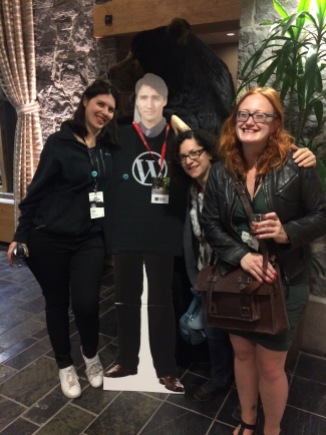 Me and 2 colleagues with a cardboard cutout of Justin Trudeau and a bear in the background
