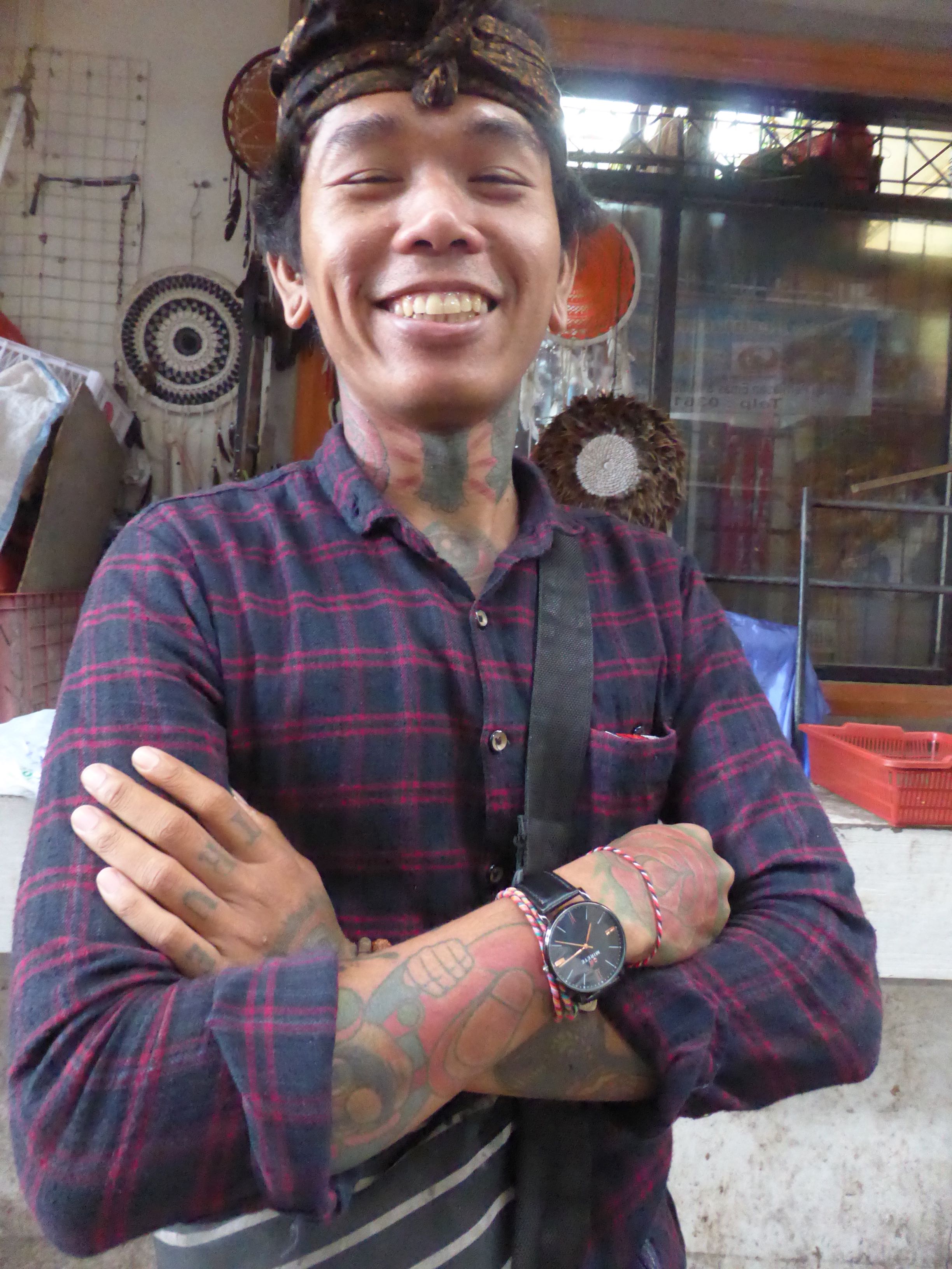 smiling man with tattoos